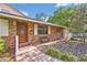 Charming brick home with brick walkway, front bench and landscaped entrance at 349 Evansdale Rd, Lake Mary, FL 32746