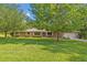 Charming brick home featuring a well-manicured lawn and mature trees at 349 Evansdale Rd, Lake Mary, FL 32746