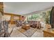 Open living room with tile floors, leather sofas, and views of the front yard at 349 Evansdale Rd, Lake Mary, FL 32746
