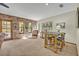 Inviting living room with brick wall, carpet flooring, and natural light from windows and outdoor access at 349 Evansdale Rd, Lake Mary, FL 32746