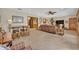 Spacious living room area with carpet flooring and a ceiling fan at 349 Evansdale Rd, Lake Mary, FL 32746