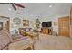 Cozy living room with plush sofas, rustic wood coffee table, ceiling fan, and a large television for entertainment at 349 Evansdale Rd, Lake Mary, FL 32746