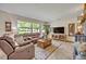 Comfortable living room with leather sofas, large window, and a television at 349 Evansdale Rd, Lake Mary, FL 32746