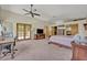 Spacious main bedroom with a ceiling fan, desk, and access to a private balcony at 349 Evansdale Rd, Lake Mary, FL 32746