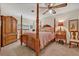 This main bedroom includes a canopy bed, wood furniture, and a ceiling fan for comfortable and stylish living at 349 Evansdale Rd, Lake Mary, FL 32746