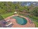 Aerial view of a Kidney-shaped brick-lined pool with lounge chairs in the backyard at 349 Evansdale Rd, Lake Mary, FL 32746