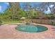 Backyard pool with brick pavers, in ground jacuzzi and a table and chairs set with an umbrella on the patio at 349 Evansdale Rd, Lake Mary, FL 32746