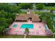 Community clubhouse with pool, shuffleboard, cabanas, pink patio, and mature landscaping at 4029 N Waterbridge Cir, Port Orange, FL 32129