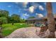 Beautiful backyard with screened pool, mature landscaping, and inviting patio seating at 4029 N Waterbridge Cir, Port Orange, FL 32129