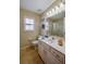 Well-lit bathroom with vanity, toilet, and shower featuring glass doors at 4029 N Waterbridge Cir, Port Orange, FL 32129