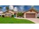 Charming single-story home with a well-manicured lawn, a vibrant turquoise door, and beautiful landscaping at 4029 N Waterbridge Cir, Port Orange, FL 32129
