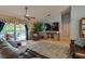 Cozy living room with a large TV, tile flooring, comfortable seating, and access to the outdoor pool area at 4029 N Waterbridge Cir, Port Orange, FL 32129