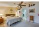 Main bedroom featuring a fan and easy access to main bathroom at 4029 N Waterbridge Cir, Port Orange, FL 32129