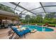 Spacious screened lanai with pool, spa, and seating offers resort-style living at 4029 N Waterbridge Cir, Port Orange, FL 32129