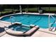 Inviting pool with hot tub and tranquil water feature offers a relaxing outdoor oasis at 4029 N Waterbridge Cir, Port Orange, FL 32129