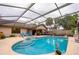 Backyard pool with screened enclosure offers a luxurious outdoor living space at 4029 N Waterbridge Cir, Port Orange, FL 32129