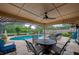 Covered outdoor patio with a pool, a ceiling fan, and comfortable seating for relaxing and entertaining at 4029 N Waterbridge Cir, Port Orange, FL 32129