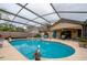 Screened-in pool with ample patio space, ideal for outdoor relaxation and entertaining at 4029 N Waterbridge Cir, Port Orange, FL 32129