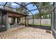 Wide angle view of backyard and enclosed patio with screened area for relaxing and entertaining outdoors at 411 Columbus Ave, Orange City, FL 32763