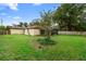 The backyard showcases a well-maintained lawn and partial view of the house at 411 Columbus Ave, Orange City, FL 32763