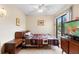 Cozy bedroom featuring tiled floor, ceiling fan, slider to the outside, and classic wood furniture at 411 Columbus Ave, Orange City, FL 32763