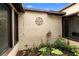 Enclosed courtyard with small garden featuring lush foliage, and a decorative emblem on the textured stucco wall at 411 Columbus Ave, Orange City, FL 32763