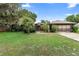 Charming single Gathering home with a well-manicured lawn and mature trees at 411 Columbus Ave, Orange City, FL 32763