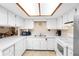 Bright kitchen with white cabinetry, appliances, and tiled floor at 411 Columbus Ave, Orange City, FL 32763