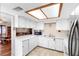 Bright kitchen featuring white cabinets, counter tops, and tiled floor at 411 Columbus Ave, Orange City, FL 32763