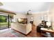 Warm living room with hardwood floors, comfortable seating, and a cozy fireplace at 411 Columbus Ave, Orange City, FL 32763