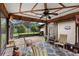 Screened patio features seating area and ceiling fan, perfect for outdoor entertaining and relaxation at 411 Columbus Ave, Orange City, FL 32763