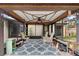Enclosed patio featuring comfortable seating, decorative lighting, and a serene view of the surrounding foliage at 411 Columbus Ave, Orange City, FL 32763