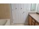 Bathroom featuring a bathtub and wood cabinets with a light countertop and a door at 421 Holly Fern Trl, Deland, FL 32720
