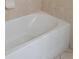 Close-up of a standard white bathtub with tiled walls and floor at 421 Holly Fern Trl, Deland, FL 32720