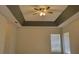 Bedroom featuring a tray ceiling with fan and a window that allows natural light at 421 Holly Fern Trl, Deland, FL 32720