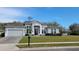 Charming one story home with lush landscaping, a well-manicured lawn, and attached garage at 421 Holly Fern Trl, Deland, FL 32720