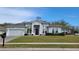 Charming one story home with lush landscaping, a well-manicured lawn, and attached garage at 421 Holly Fern Trl, Deland, FL 32720