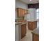 Spacious kitchen with granite countertops, wood cabinets, and a kitchen island at 421 Holly Fern Trl, Deland, FL 32720
