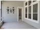 Screened-in patio with concrete floor, metal wall art, and white trim windows at 421 Holly Fern Trl, Deland, FL 32720
