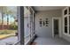 View of screened patio with decorations on gray wall and door leading to the outside at 421 Holly Fern Trl, Deland, FL 32720