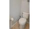 Close-up of a standard white toilet and toilet paper dispenser with tile flooring at 421 Holly Fern Trl, Deland, FL 32720