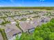 Aerial view of a vibrant neighborhood with lush green trees, well-maintained homes, and screened in swimming pools at 425 Wedgeworth Ln, Deland, FL 32724