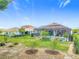 Expansive backyard featuring a screened-in pool, landscaped garden, and a view of the neighboring houses at 425 Wedgeworth Ln, Deland, FL 32724