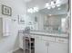 Bright bathroom features a granite countertop vanity with a large mirror and glass enclosed shower at 425 Wedgeworth Ln, Deland, FL 32724
