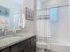 Bathroom featuring a granite countertop, white tile, and a shower with a white curtain at 425 Wedgeworth Ln, Deland, FL 32724