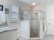 Bathroom features a glass enclosed corner shower, single sink vanity with granite countertops and window with shutters at 425 Wedgeworth Ln, Deland, FL 32724