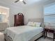 Comfortable bedroom featuring a large bed, a dresser, and a doorway to an ensuite bathroom at 425 Wedgeworth Ln, Deland, FL 32724