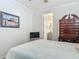 Bedroom features a tv and a dresser, along with a bathroom that is accessible from the bedroom at 425 Wedgeworth Ln, Deland, FL 32724