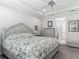Bedroom with crown molding, ceiling fan, light gray walls, floral comforter and en suite bath at 425 Wedgeworth Ln, Deland, FL 32724