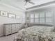 Bedroom featuring a floral comforter, ceiling fan, light gray furniture, multiple windows and crown molding at 425 Wedgeworth Ln, Deland, FL 32724